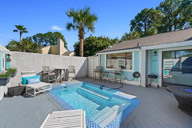 view of swimming pool with a wooden deck