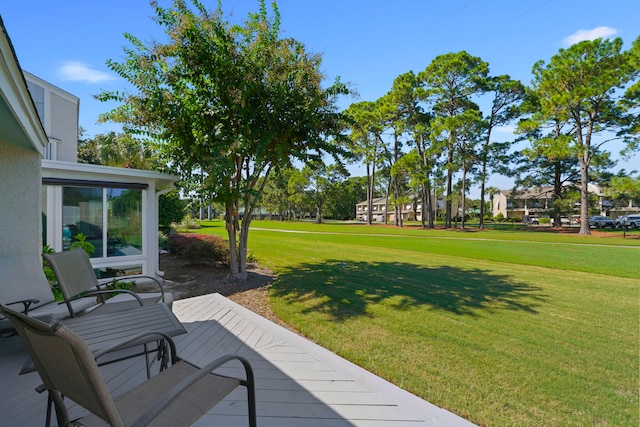 wooden deck featuring a lawn