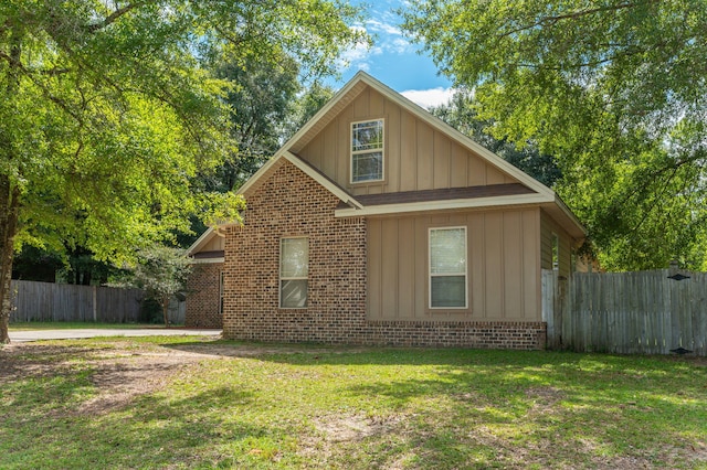 view of side of property with a lawn