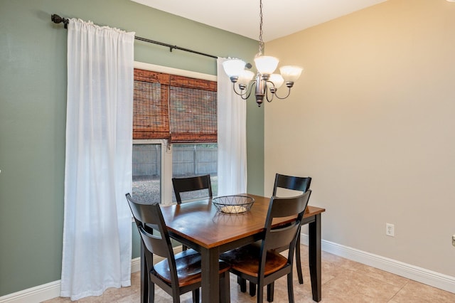 tiled dining space with an inviting chandelier