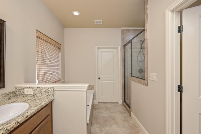 bathroom with vanity, an enclosed shower, and tile patterned floors