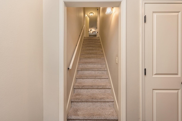 stairs featuring carpet flooring