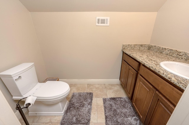 bathroom featuring tile patterned flooring, vanity, and toilet