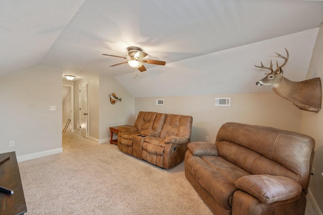 carpeted living room with ceiling fan and lofted ceiling