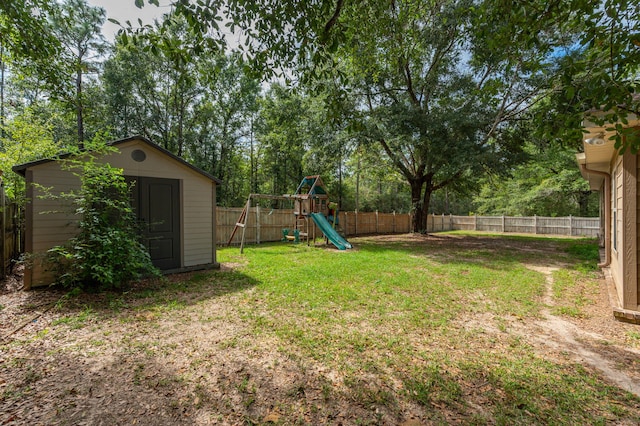 view of yard featuring a playground and a storage shed