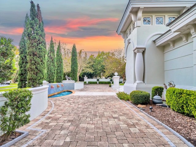 view of patio terrace at dusk