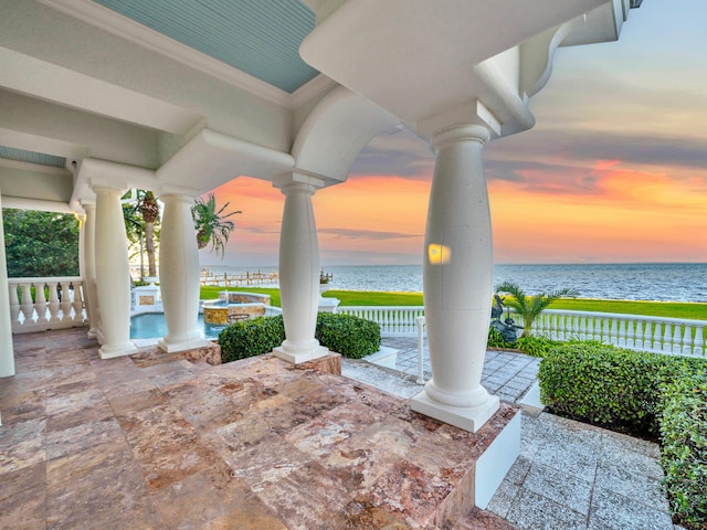 patio terrace at dusk with a water view