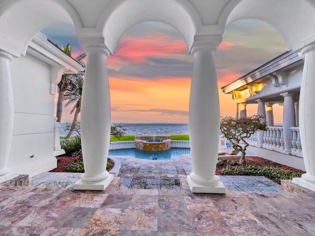 patio terrace at dusk with a water view