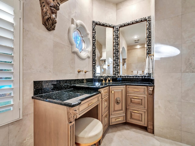 bathroom featuring tile patterned floors, vanity, and tile walls