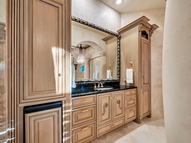 bathroom with tile patterned flooring, vanity, and tile walls