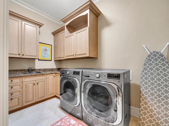 laundry room with cabinets, separate washer and dryer, crown molding, and sink