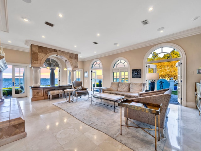 living room featuring a water view, crown molding, a wealth of natural light, and french doors