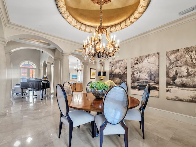 dining room with a tray ceiling, ornate columns, crown molding, and a notable chandelier