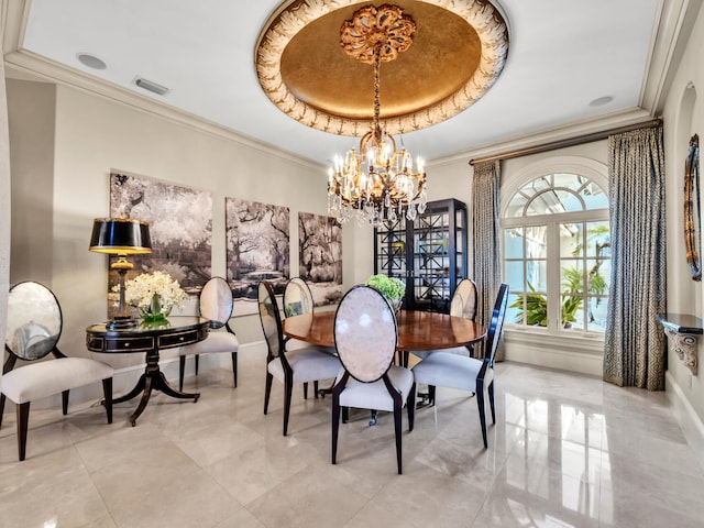 dining room with a chandelier, a tray ceiling, and crown molding