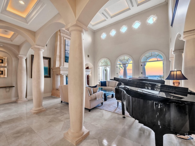 miscellaneous room featuring beamed ceiling, ornamental molding, a towering ceiling, and coffered ceiling