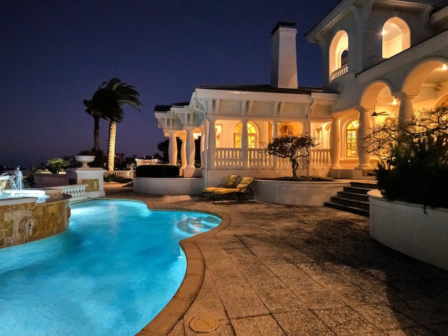 pool at twilight with pool water feature