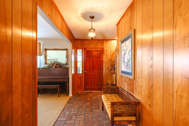 foyer featuring wooden walls