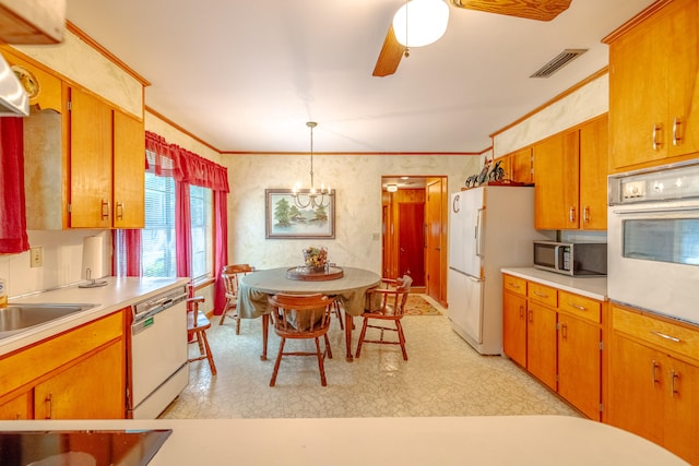 kitchen with ceiling fan with notable chandelier, white appliances, crown molding, decorative light fixtures, and sink