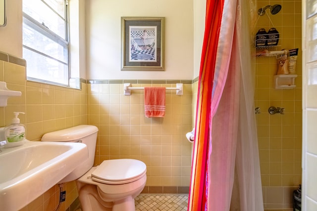 bathroom featuring walk in shower, tile walls, and toilet