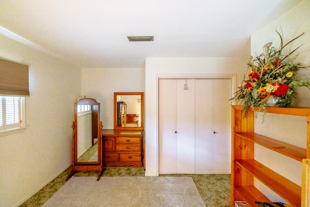 bedroom featuring light colored carpet and a closet