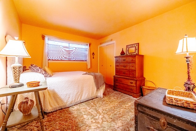 bedroom featuring carpet and vaulted ceiling