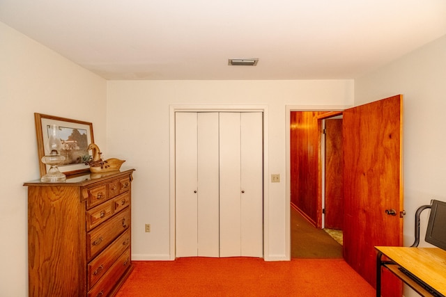 bedroom with a closet and light colored carpet