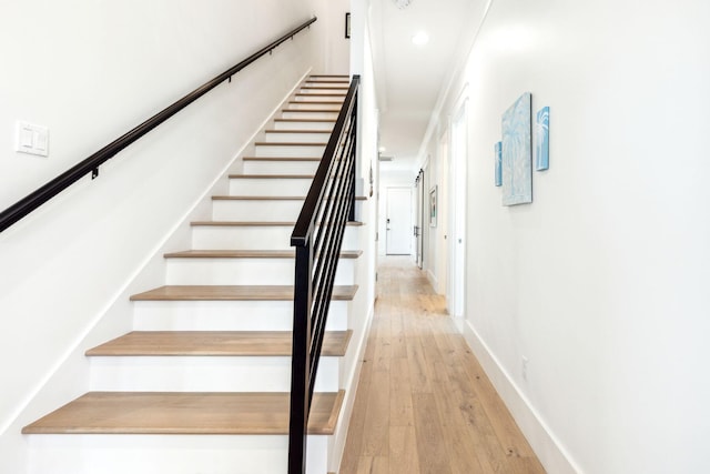 staircase with hardwood / wood-style flooring