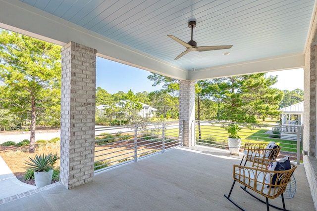 view of patio / terrace with ceiling fan and a balcony