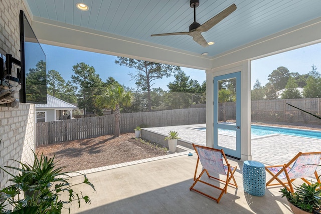 view of patio / terrace with a fenced in pool and ceiling fan