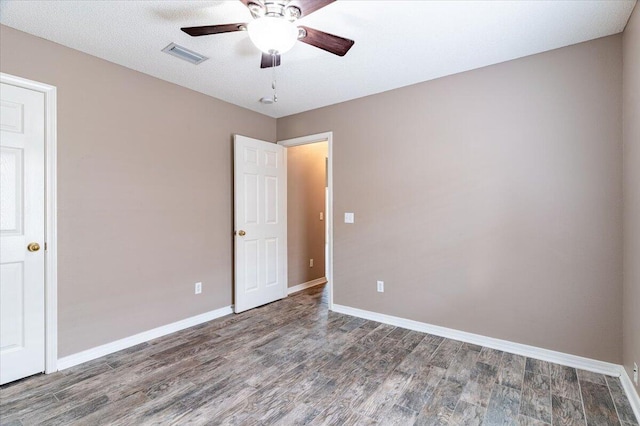 unfurnished room featuring dark hardwood / wood-style floors, a textured ceiling, and ceiling fan