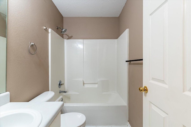 full bathroom featuring vanity, a textured ceiling, toilet, and washtub / shower combination