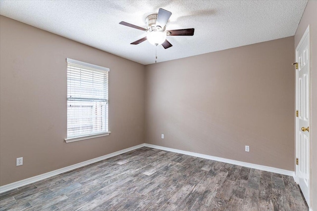 unfurnished room with ceiling fan, a textured ceiling, and dark wood-type flooring