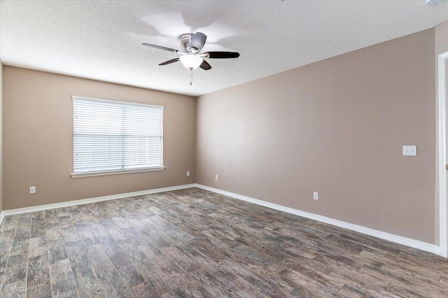 empty room featuring ceiling fan, dark hardwood / wood-style flooring, and a textured ceiling