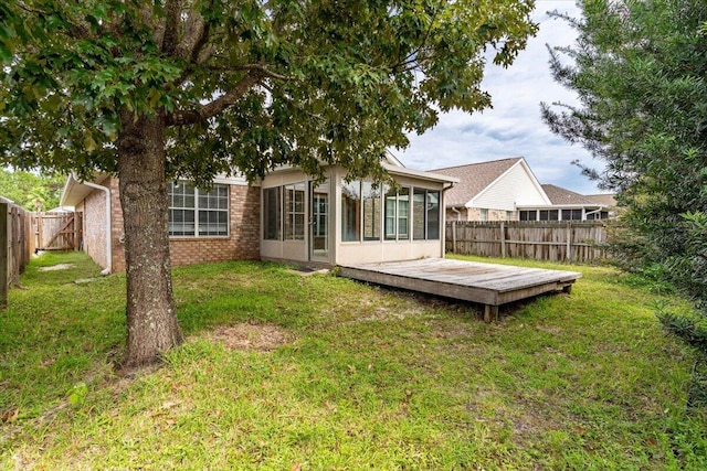 back of house with a yard and a wooden deck