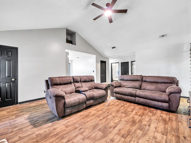 living room featuring light hardwood / wood-style floors, high vaulted ceiling, and ceiling fan