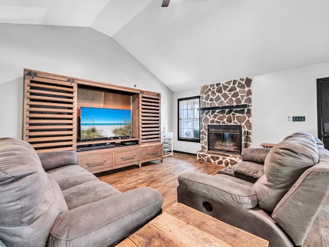 living room with a fireplace, wood-type flooring, and vaulted ceiling