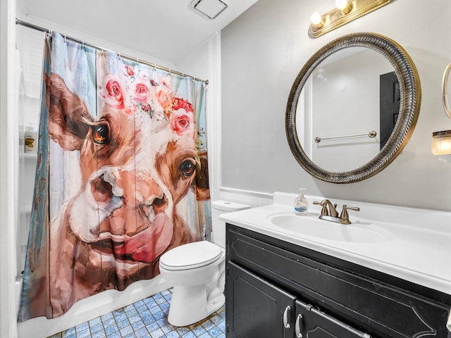 full bathroom featuring shower / bath combination with curtain, vanity, tile patterned flooring, and toilet