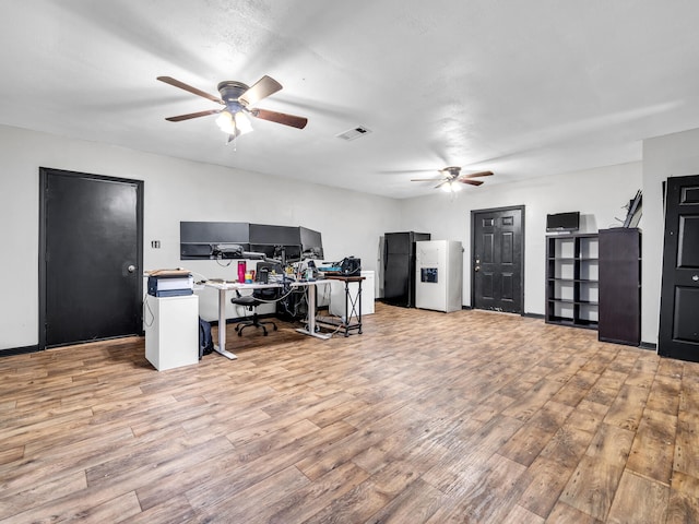 office space with light wood-type flooring and ceiling fan