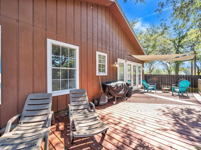 deck featuring french doors and a grill