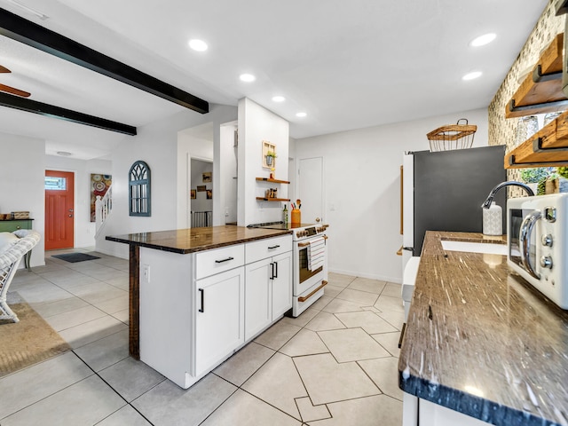 kitchen featuring beam ceiling, white cabinetry, light tile patterned floors, and electric range