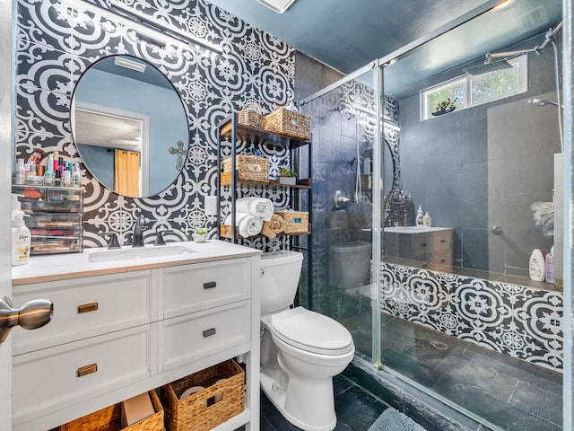 bathroom featuring walk in shower, vanity, tile patterned flooring, and toilet