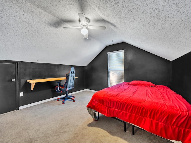 bedroom featuring carpet floors, vaulted ceiling, a textured ceiling, and ceiling fan