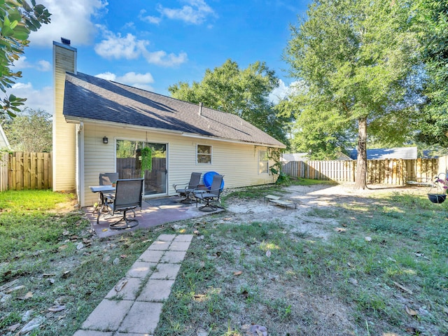 back of house featuring a yard and a patio