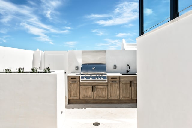 view of patio / terrace with exterior kitchen, grilling area, and sink