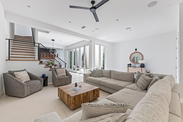 living room featuring ceiling fan and french doors