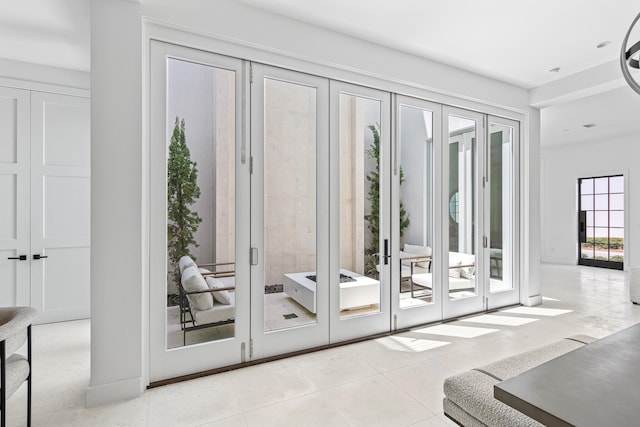 doorway to outside featuring light tile patterned floors