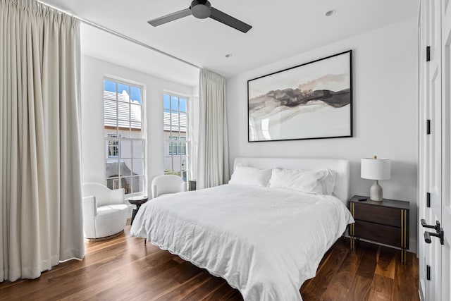 bedroom with ceiling fan and dark hardwood / wood-style flooring