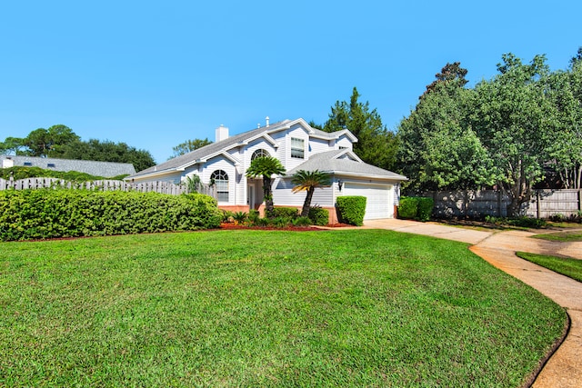 view of front facade with a garage and a front lawn