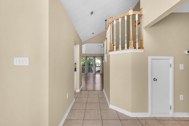 880 Brande Ct, Shalimar, FL 32579 - hall with light tile patterned flooring, high vaulted ceiling, and baseboards