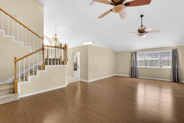 unfurnished living room featuring dark hardwood / wood-style floors, ceiling fan with notable chandelier, and high vaulted ceiling